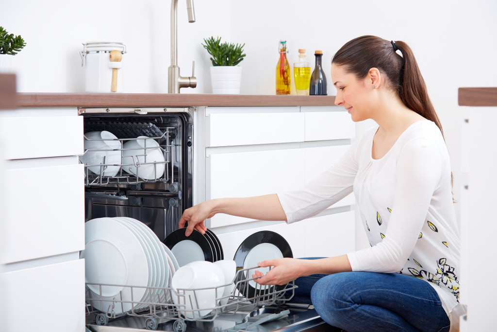 woman loading up the dishwasher