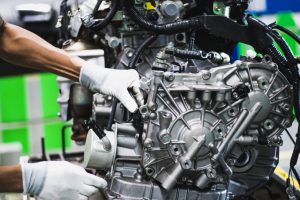 production line working checking an engine of a car