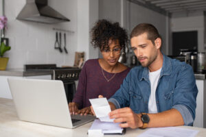 a man and woman checking financial accounts